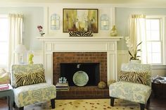 a living room filled with furniture and a fire place in front of a painting on the wall