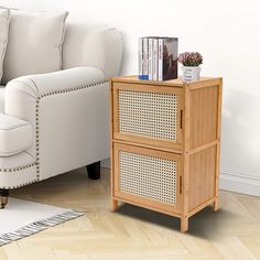 a white couch sitting next to a wooden table on top of a hard wood floor