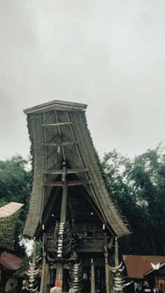 an old wooden structure in the middle of trees