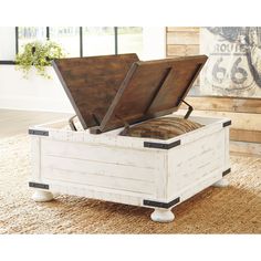 an open storage box sitting on top of a carpeted floor next to a window