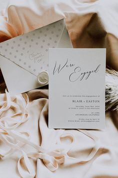 a wedding card and envelope on a bed