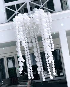 a bunch of balloons hanging from the ceiling in front of a building that says beach blvd