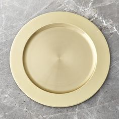 an empty white plate sitting on top of a marble counter