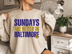 a woman wearing a sweatshirt that says sunday's are better in baltimore