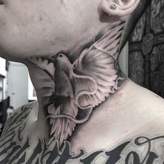 a man with a bird tattoo on his neck