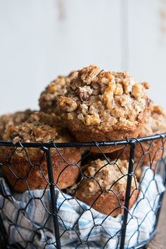 muffins in a wire basket on top of a table