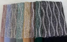 several different colors of sequins are shown in this image, including black, white, blue, green and gold