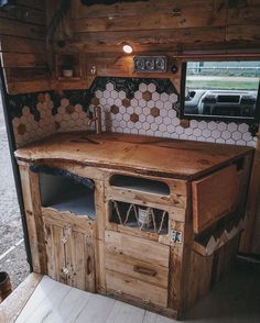 a kitchen area with wooden cabinets and tile backsplashing on the side wall