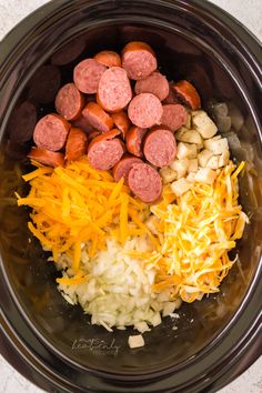 the ingredients for sausage and potato soup in a crock pot ready to be cooked