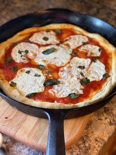 a pizza sitting on top of a pan covered in cheese and sauces next to a spatula