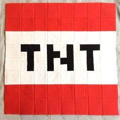 a piece of red and white fabric with the word th on it in black letters