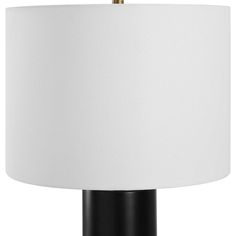 a black and white lamp with a white shade