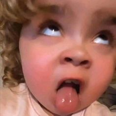 a young child making a funny face while sticking his tongue out