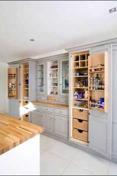 a kitchen with lots of wooden cabinets and drawers