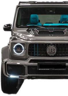 the front end of a silver mercedes g - class suv