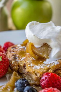 a piece of french toast topped with whipped cream and fruit