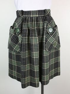 "Darling 50s / 60s plaid gathered wool skirt XS unlined....colors are green, black & cream 2 front patch pockets with large button 2 wide front belt loops....metal back zipper some expertly mended holes throughout back of skirt has the most noticeable  ....others blend in well & not able to easily find light stains on & under front left pocket no labels....please see photos for flaws ✧ NO REFUNDS ✧ PLEASE CAREFULLY CHECK MEASUREMENTS !! no size label ✧ fits like a size xs waist ✧ 11 1/2\" ( laying flat ) hips ✧ open length ✧ 20 1/2\"  condition ✧ good vintage condition ✧ contact me if you have any questions or want more pictures ✧ contact me if you want combined shipping  SMOKE FREE ENVIRONMENT" Vintage Combat Boots, Green Plaid Skirt, Plaid Wool Skirt, Skirt Short, Short Sleeve Cardigan, Wool Skirt, Large Buttons, Plaid Skirt, Size Label