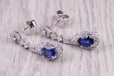 Very beautiful and very dressy natural Blue Sapphire and Diamond set dropper earrings Set with Oval cut Sapphires weighing 2.26 carat in total and Diamonds weighing 1.18ct  Natural Diamonds and natural Rubies Top grade Emeralds and Diamonds Total Gemstone weight of 3.44 carats Made from 18ct White Gold  Earrings measures 30 mm long X 8.50 mm wide  British hallmarked  Perfect Anniversary present This is the perfect Christmas, birthday, anniversary or graduation present idea. Ideal as gift idea fo Formal Sapphire Earrings With Diamond Cut, Elegant Blue Diamond Cut Earrings, Elegant Blue Diamond-cut Earrings, Blue Brilliant Cut Diamond Earrings For Formal Events, Blue Diamond Earrings For Formal Occasions, Formal Blue Pear-shaped Diamond Earrings, Elegant Sapphire Earrings With Diamond Cut, Blue Diamond Drop Earrings For Formal Occasions, Elegant Blue Diamond Dangle Earrings