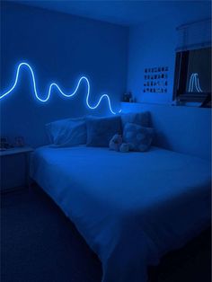 a bed in a room with blue lights on the wall