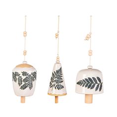 three ceramic ornaments hanging from strings with leaves on them and beaded beads around the edges