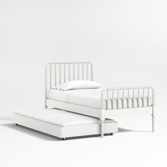 a white bed sitting on top of a white floor