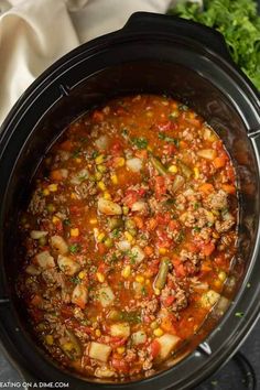 a crock pot filled with meat and vegetables