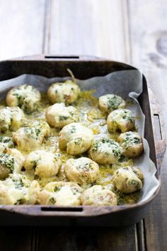 a casserole dish with broccoli and cheese in it on a wooden table