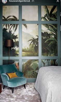 the bedroom is decorated with tropical wallpaper and green chairs, along with a bed