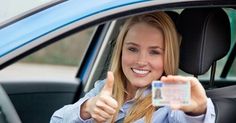 a woman is sitting in her car giving the thumbs up