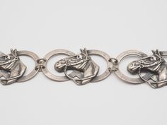 "Listing is for a Vintage Art Studio sterling silver horse shoe relief equestrian panel bracelet. Beautiful, handmade horse panels cut out bracelet. Bracelet measures 7.5\" end to end, width is 19mm/ 0.7\". Weight is 16.8 grams. Original patina is preserved, can be easily removed with gentle cleaning. Unique piece for horse lovers! Thank you! (N82)" Silver Horse Design Bracelet Jewelry, Silver Horse Design Jewelry Bracelet, Vintage Silver Jewelry With Horse Design, Collectible Silver Horse Design Jewelry, Vintage Art Studio, Floral Cuff, Silver Horse, Silver Chain Style, Horse Shoe