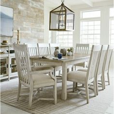 a dining room table with chairs and a lantern hanging from the light fixture above it