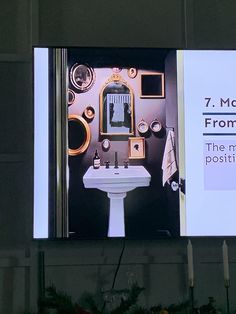 an advertisement for a bathroom is displayed on the wall above a pedestal sink and mirror