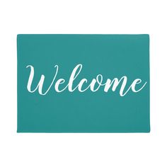 a welcome mat with the word welcome written in white on a teal green background