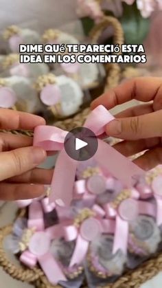 two hands are holding pink ribbon in front of a basket filled with confetti