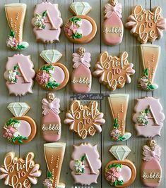 decorated cookies are arranged in the shape of bride and groom's initials on display