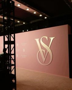 a stage set up in front of a pink wall with the word s and w on it