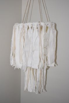 a hanging mobile made out of white fabric