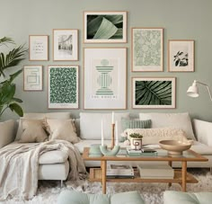 a living room filled with white furniture and pictures on the wall above it's coffee table