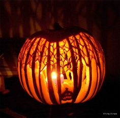 a carved pumpkin sitting on top of a table with a candle in it's mouth