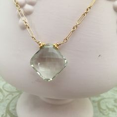 This is a pretty necklace that looks good with a black top or a "power" suit. It looks great on all complexions. The gemstones are AAA in quality. Stunning prasiolite (green amethyst) pendant, measuring 23mm x 23mm. The prasiolite pendant is cushion cut and transparent. The pendant hangs from a 14K GF chain, adorned with 6mm fuchsia rondells. Elegant Gold Amethyst Crystal Necklaces, Elegant Faceted May Birthstone Necklaces, Elegant Green Amethyst Jewelry For Gifts, Faceted Green Amethyst Necklace As A Gift, Elegant Green Gemstone Crystal Necklace, Faceted Green Amethyst Necklace Gift, Elegant Faceted Green Amethyst Jewelry, Gift Green Amethyst Gold Necklaces, Elegant Amethyst Necklace With Diamond Cut