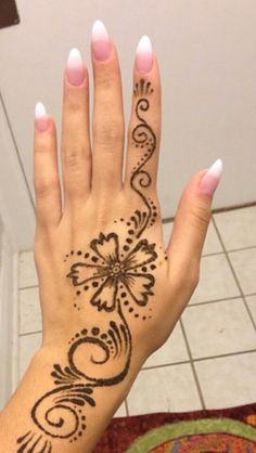 a woman's hand with hendix on it and an intricate flower design