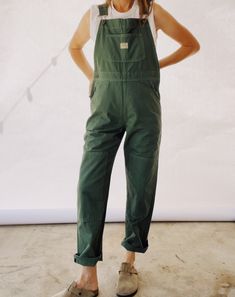 Our bestselling Kneepatch Overalls made with 100% Cotton garment dyed Herringbone Twill. These are based off of our favorite vintage pair of overalls with a slightly shrunken boyish fit. They are a slimmer fit compared to our miner overalls. Adjustable straps, front bib pocket, branded copper hardware. Model in the photo has a 26" waist / 36" hips and is wearing a size 0. Overalls With Boots Outfits, Long Sleeve With Overalls, Women’s Overall Outfits, No Waist Body Shape Outfit, Women’s Overalls, Barista Outfit Casual, Cute Gardening Outfits, Garden Outfit Aesthetic, Hiking Overalls