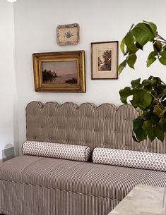 a living room filled with furniture and pictures on the wall