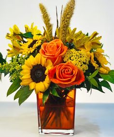 a vase filled with orange and yellow flowers