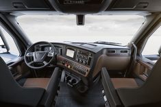 the interior of a vehicle with dashboard, steering wheel and other equipment in front of it