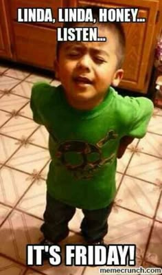 a little boy standing on top of a kitchen floor next to a wooden cupboards