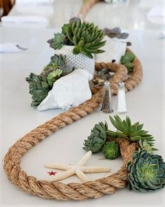 the table is decorated with rope and succulents