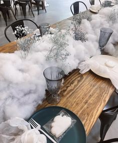 the table is covered with cotton and other things to make it look like they are floating