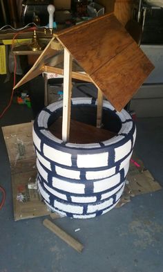 a small house sitting on top of a wooden table in a potted planter