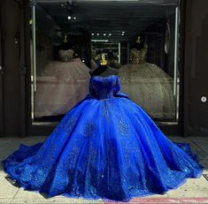 Details: Silhouette: Ball-Gown Style Fabric: Tulle Fabric Color: Royal Blue Color Length: Chapel-Train Neckline: Off-the-Shoulder Neckline Sleeves: Sleeveless Back: Lace-Up Back Embellishment: Appliqued, Bow-Knot Chambelanes Outfits Quinceanera Blue, Quinceanera Dresses With Train, Royal Blue 15 Dresses Quinceanera, Chambelan Outfits, Blue Quince Dress, Royal Entrance, Royal Blue Ball Gown, Gowns Pageant, Royal Blue Quinceanera Dresses